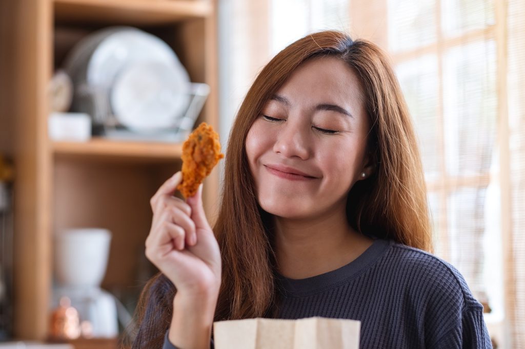 Woman eating fried chicken