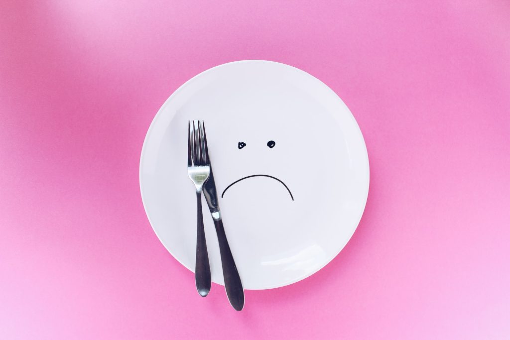 plate with sad face drawn on it